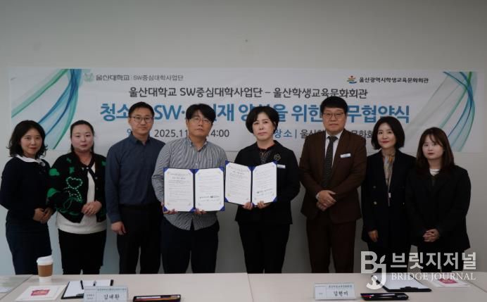 울산학생교육문화회관 김현미 관장(오른쪽)과 김대환 울산대학교 성과확산센터장이 업무협약을 체결하고 기념사진을 찍고있다